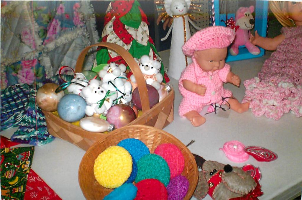 Picture of a baby doll  and a basket wiht decorated eggs